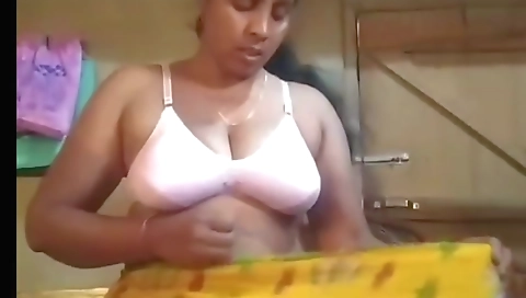 Indian hottie in a dress with her big tits in solo video