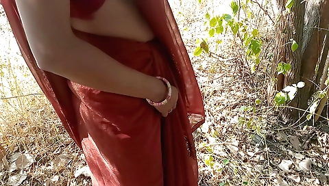 Indian teen in a black suit outdoors plays with her body